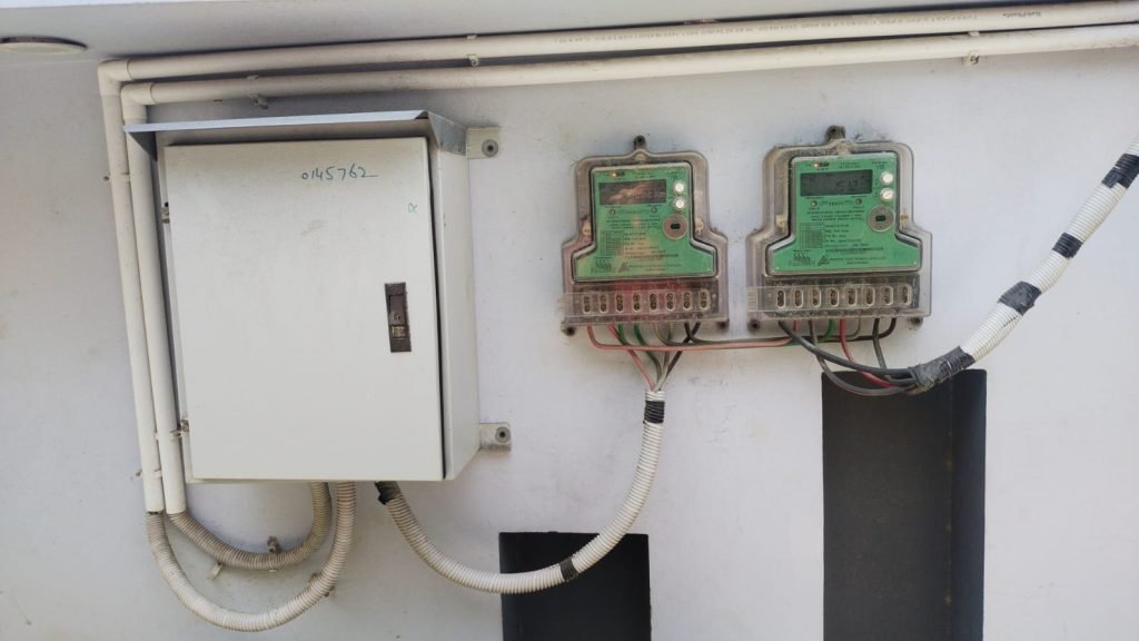 Two FESCO net meters and a distribution box on a wall